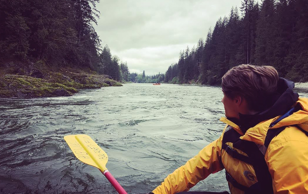 Guide looking downriver on a scenic float, the next raft ahead